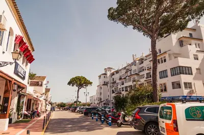 a city street with parked cars and buildings at Gallery Vistahermosa in El Puerto de Santa María