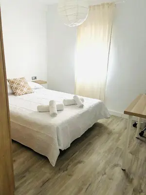 a bedroom with a bed with two towels on it at La Joya de Apartamento in Jerez de la Frontera