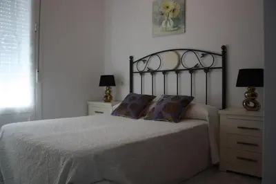 a bedroom with a bed with two pillows on it at Apartamento Centro Plaza del Cabildo in Sanlúcar de Barrameda