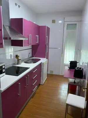 a kitchen with purple cabinets and a sink at Apartamento Centro Plaza del Cabildo in Sanlúcar de Barrameda