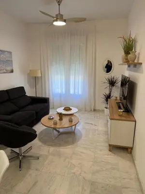 a living room with a couch and a coffee table at Apartamento Centro Plaza del Cabildo in Sanlúcar de Barrameda