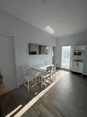 a white dining room with a table and chairs at Alojamiento rural colarte in Conil de la Frontera