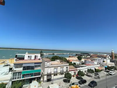 an aerial view of a city with the ocean at Apartamento Baluarte in Sanlúcar de Barrameda