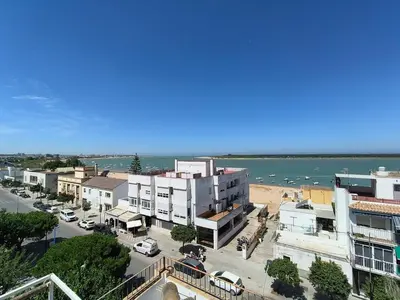 an aerial view of a city with a beach and buildings at Apartamento Baluarte in Sanlúcar de Barrameda