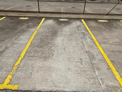 a parking lot with two yellow lines on a street at Apartamento La Laguna in Chipiona