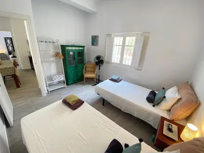 a living room with two beds and a couch at Casa Santo Domingo, Centro-Playa in Chipiona