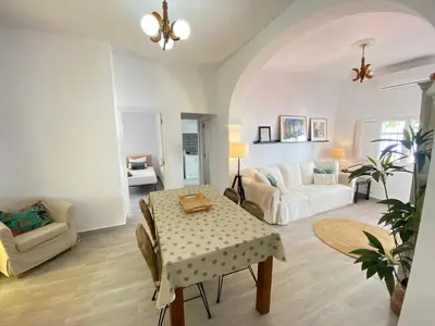 a living room with a table and a couch at Casa Santo Domingo, Centro-Playa in Chipiona