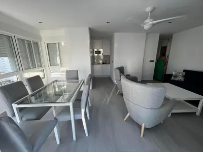 a living room with a glass table and chairs at Apartamento Arena y sal in El Puerto de Santa María