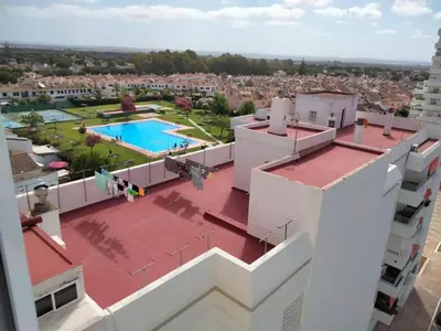 a view from the roof of a building with a swimming pool at Apartamento Arena y sal in El Puerto de Santa María