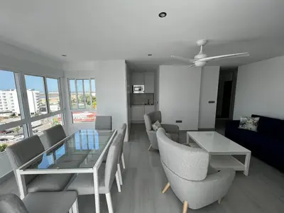 a living room with a couch and a table and chairs at Apartamento Arena y sal in El Puerto de Santa María