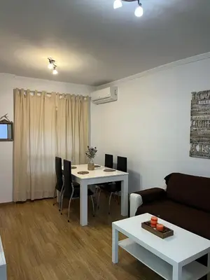 a living room with a white table and a couch at Ático de Marta, Pleno Centro-Terraza 34m2 in Sanlúcar de Barrameda