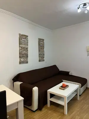 a living room with a couch and a table at Ático de Marta, Pleno Centro-Terraza 34m2 in Sanlúcar de Barrameda