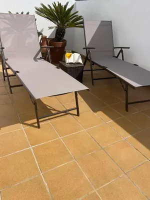 two chairs sitting on top of a tile floor at Ático de Marta, Pleno Centro-Terraza 34m2 in Sanlúcar de Barrameda