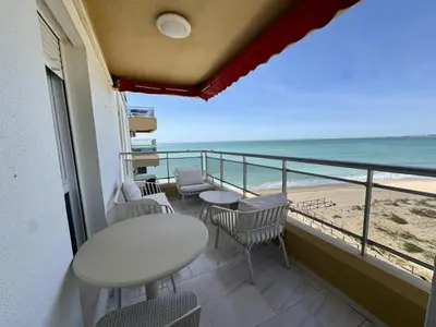 a balcony with a table and chairs and the beach at El Vigia Grupo AC Gestion in Vista Hermosa