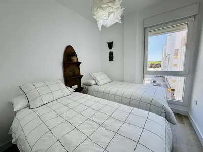 a bedroom with two beds and a window at El Vigia Grupo AC Gestion in Vista Hermosa