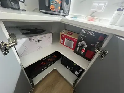 a small kitchen with a refrigerator with a drawer at Apartamento Castillo Deluxe in Sanlúcar de Barrameda