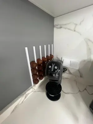 a coffee maker sitting on a counter next to a wall at Apartamento Castillo Deluxe in Sanlúcar de Barrameda