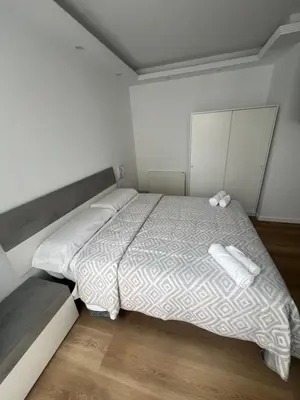 a bedroom with a bed with two white towels on it at Apartamento Castillo Deluxe in Sanlúcar de Barrameda