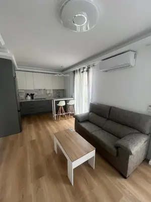 a living room with a couch and a table at Apartamento Castillo Deluxe in Sanlúcar de Barrameda