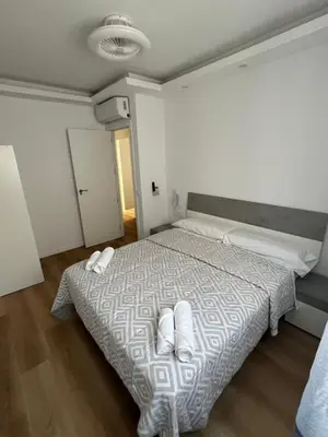 a bedroom with a bed with white towels on it at Apartamento Castillo Deluxe in Sanlúcar de Barrameda