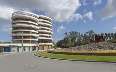 a bedroom with a large bed with white sheets at Sunset Vibes at Sky Garden Jerez in Jerez de la Frontera
