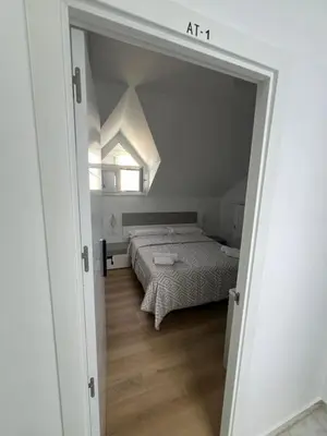 a small bedroom with a bed and a window at Habitaciones Castillo Deluxe in Sanlúcar de Barrameda