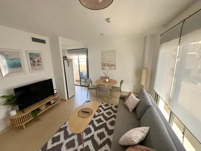 a living room with a couch and a table at Luminoso Apartamento con Balcón in El Puerto de Santa María