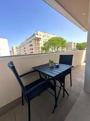 a black table and chairs on a balcony with a view at Luminoso Apartamento con Balcón in El Puerto de Santa María
