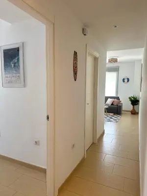 a hallway with a door leading to a living room at Luminoso Apartamento con Balcón in El Puerto de Santa María