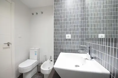 a white bathroom with a sink and a toilet at Luminoso Apartamento con Balcón in El Puerto de Santa María