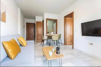 a living room with a couch and a table at Luminoso y acogedor apartamento en el centro in El Puerto de Santa María