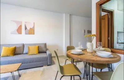 a living room with a blue couch and a table at Luminoso y acogedor apartamento en el centro in El Puerto de Santa María