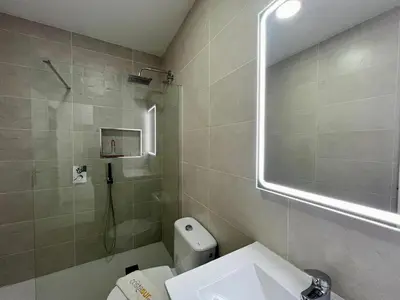 a bathroom with a shower and a toilet and a sink at Apartamento Pescadores in Chiclana de la Frontera