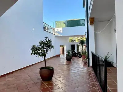 a courtyard with potted plants in a building at Apartamento Pescadores in Chiclana de la Frontera