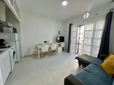 a living room with a couch and a table at Apartamento Pescadores in Chiclana de la Frontera