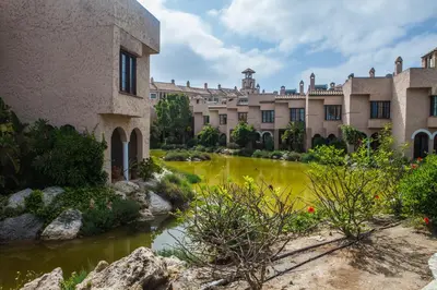 a courtyard of a building with a river at Estudios Turísticos Bahia Sur in San Fernando