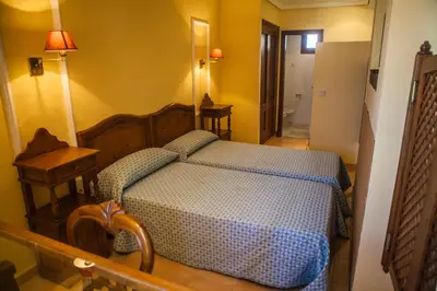 a bedroom with a wooden bed in a room at Estudios Turísticos Bahia Sur in San Fernando