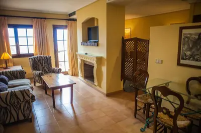 a living room filled with furniture and a fireplace at Estudios Turísticos Bahia Sur in San Fernando