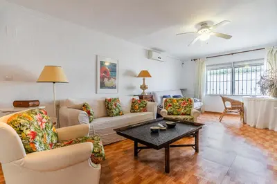 a living room with couches and a table at La Casona in Chiclana de la Frontera