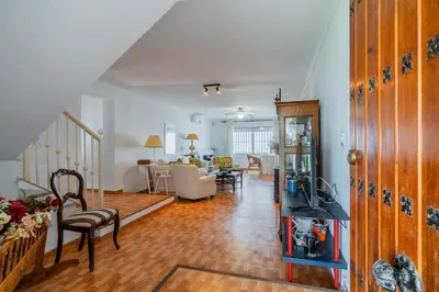 a living room with a couch and a dining room at La Casona in Chiclana de la Frontera