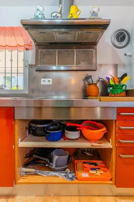a kitchen with a counter with pots and pans at La Casona in Chiclana de la Frontera