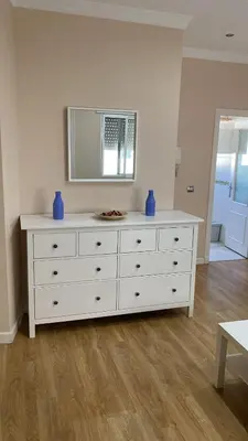 a white dresser with blue vases on top of it at Piso Palacio centro in El Puerto de Santa María