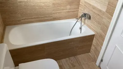 a white bath tub in a bathroom with a toilet at Piso Palacio centro in El Puerto de Santa María
