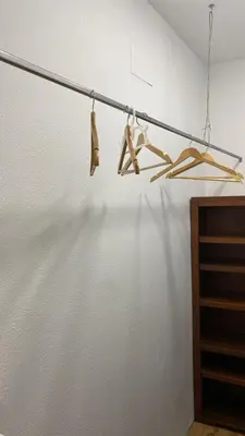 two hangers are hanging on a pole in a room at Piso Palacio centro in El Puerto de Santa María