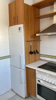 a kitchen with a white refrigerator and a stove at Piso Palacio centro in El Puerto de Santa María