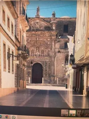 an old building with a door in a street at Piso Palacio centro in El Puerto de Santa María