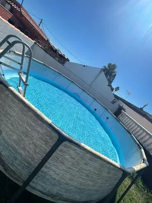 a swimming pool with two chairs on top at Sun and relaxation Book your paradise in Chiclana de la Frontera