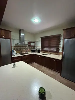 a large kitchen with wooden cabinets and a white counter top at Sun and relaxation Book your paradise in Chiclana de la Frontera