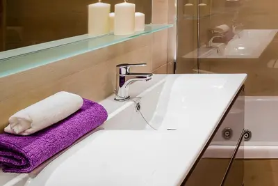 a bathroom sink with a towel and a faucet at Apartamento Vistabella in Cádiz