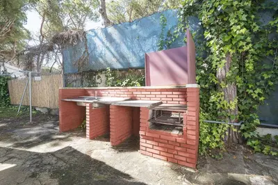 a brick barbecue with a bench on top of it at Las Camelias in Chiclana de la Frontera